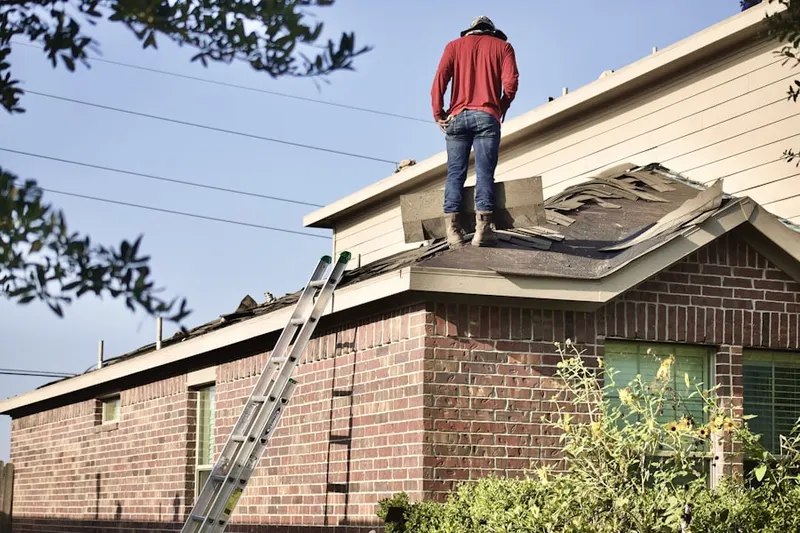 Professional roofer working on a residential roof in Shell Beach